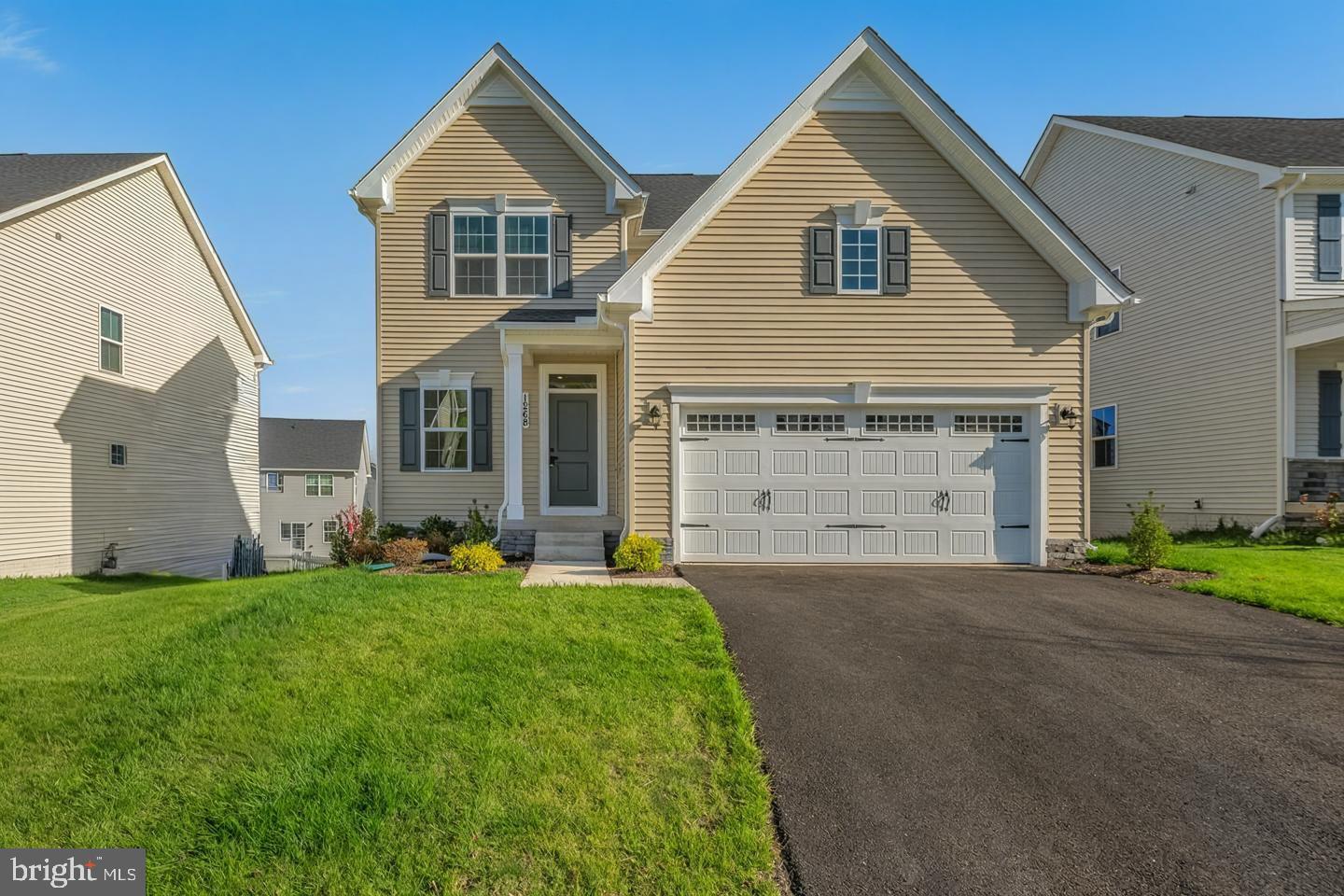 a front view of a house with a yard and garage