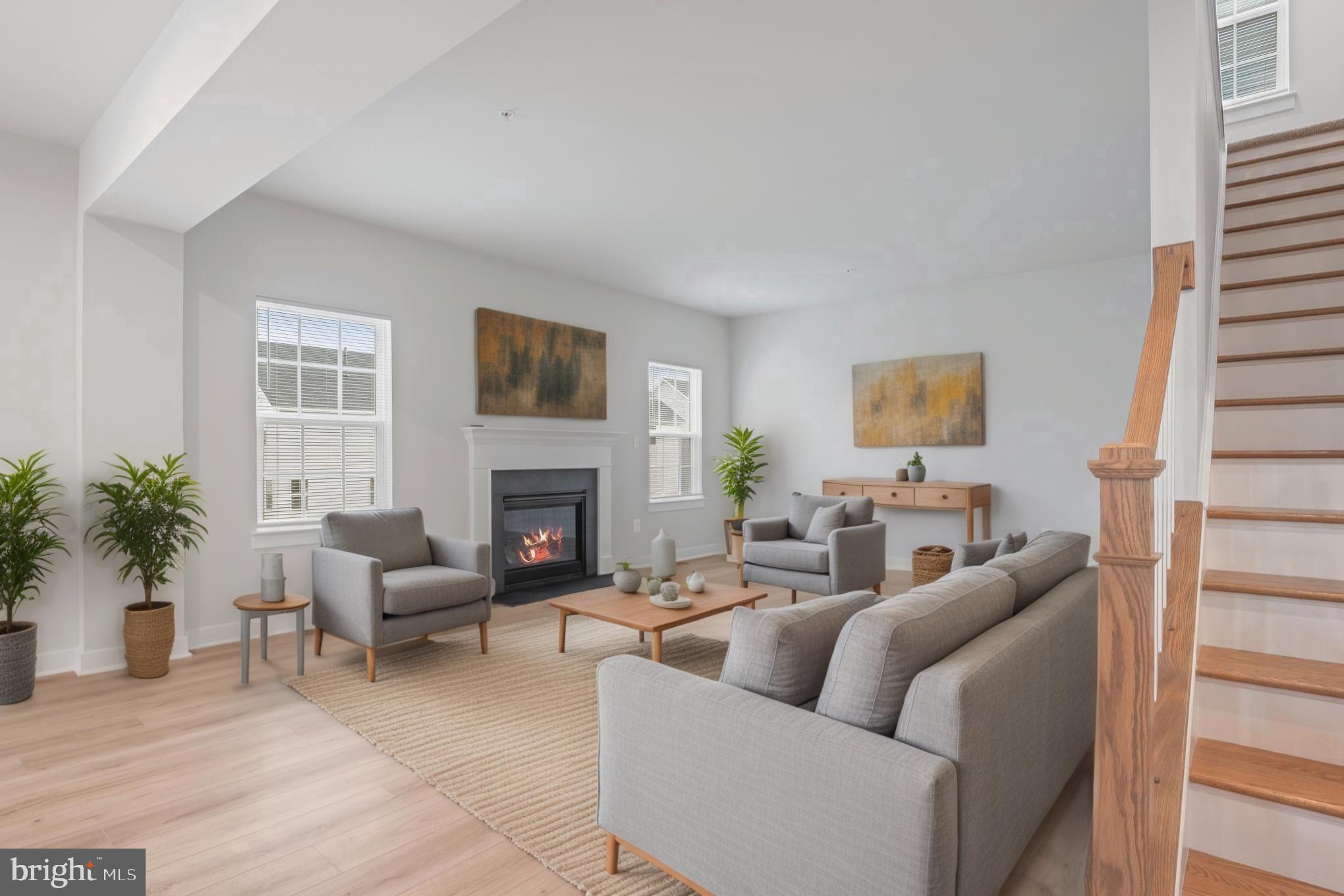 1268 Backbone Way Frederick, MD 21702 - Photo 28 of 92 a living room with furniture a fireplace a potted plant and a window