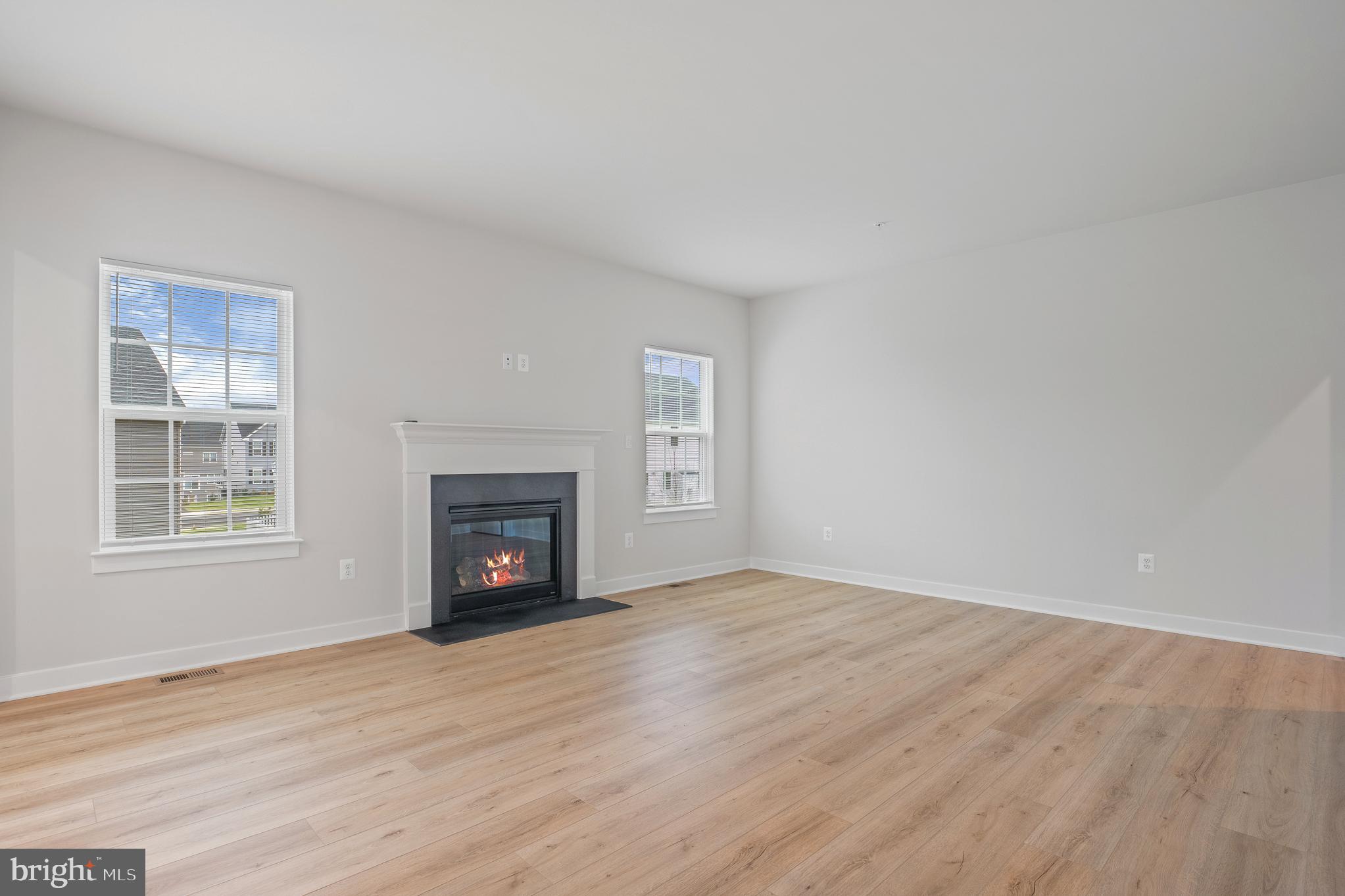 1268 Backbone Way Frederick, MD 21702 - Photo 30 of 92 a view of an empty room with wooden floor fireplace and a window