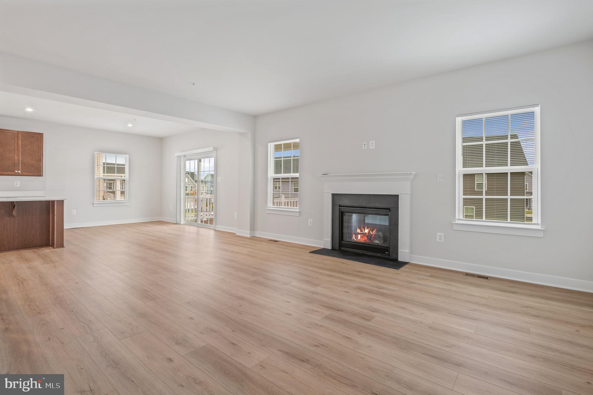 1268 Backbone Way Frederick, MD 21702 - Photo 33 of 92 a view of an empty room with wooden floor fireplace and a window