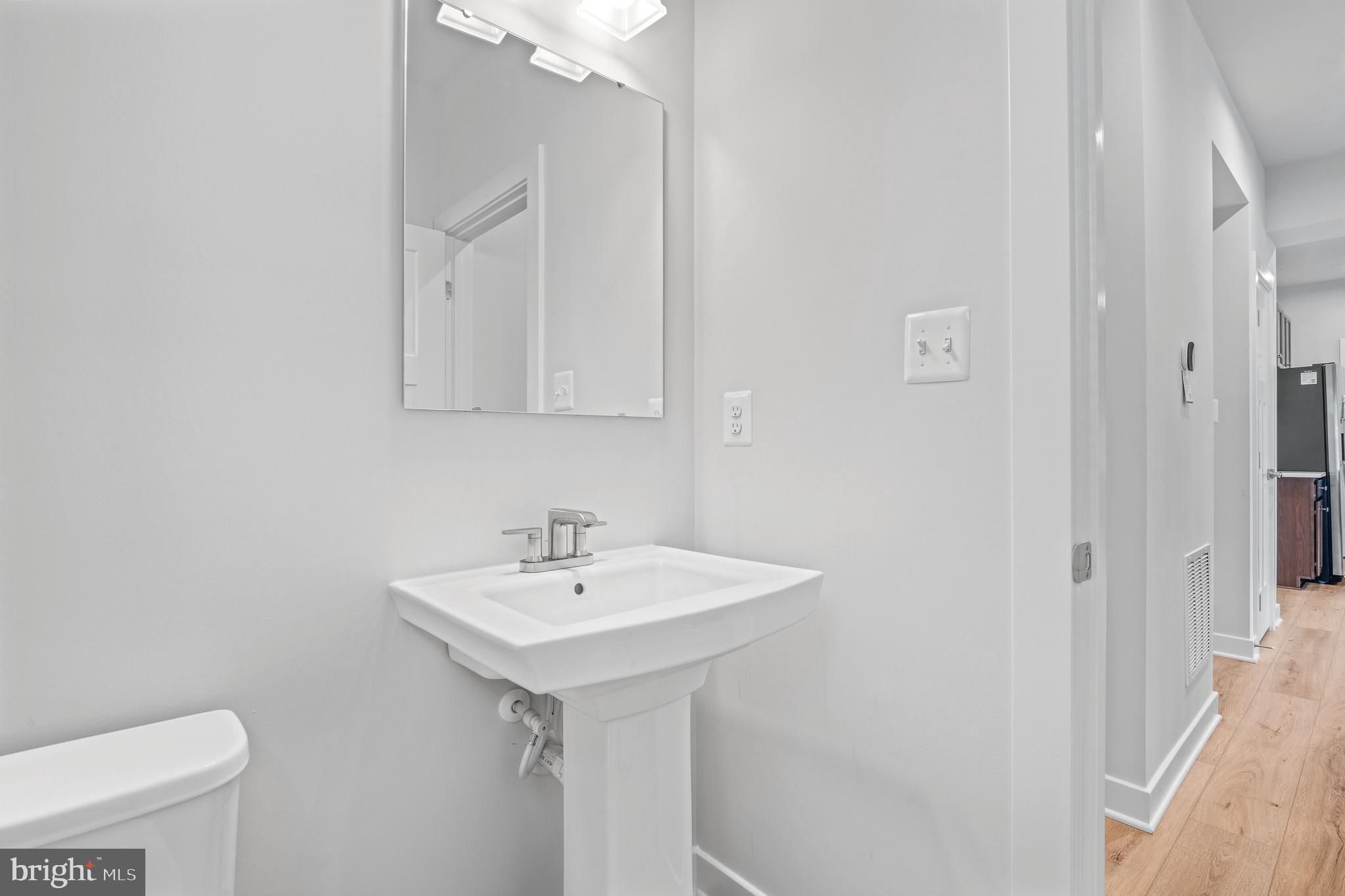 1268 Backbone Way Frederick, MD 21702 - Photo 37 of 92 a bathroom with a sink a toilet and a mirror
