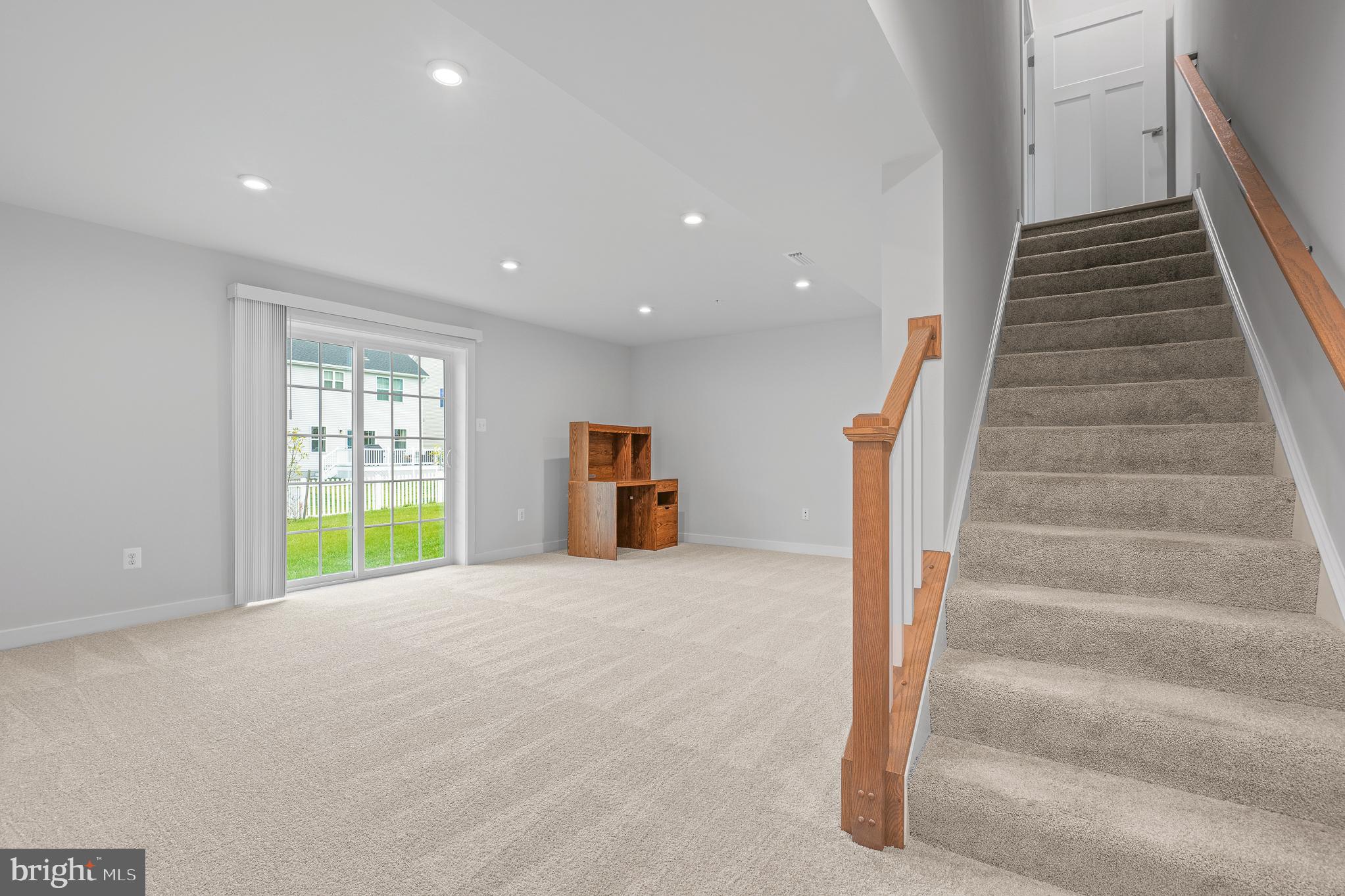 1268 Backbone Way Frederick, MD 21702 - Photo 67 of 92 a view of an empty room with stairs and a window