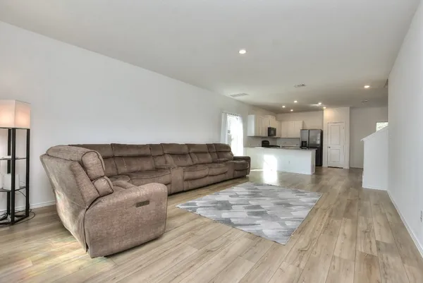 a living room with furniture and kitchen view