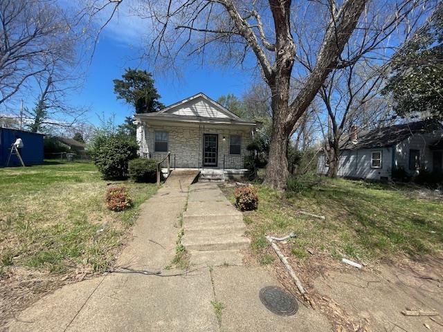 3032 McAdoo Avenue Memphis, TN 38112 - Photo 1 of 14 Bungalow-style house featuring stone siding, a front yard, and covered porch