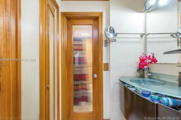 a bathroom with a granite countertop shower a mirror and a sink