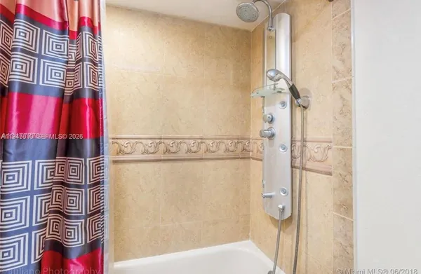 a bathroom with a bathtub and shower