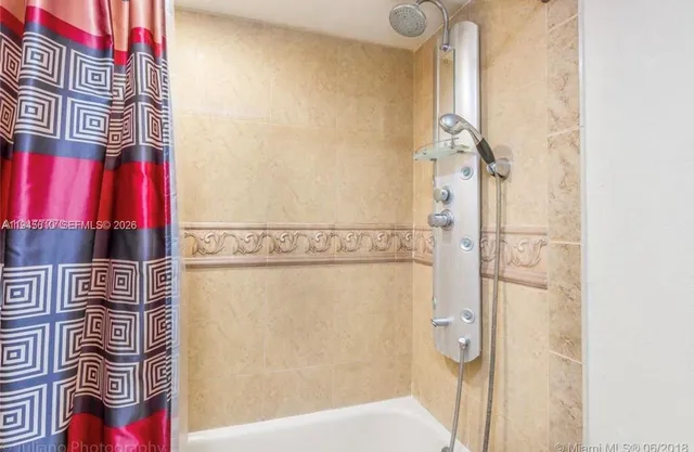 a bathroom with a bathtub and shower