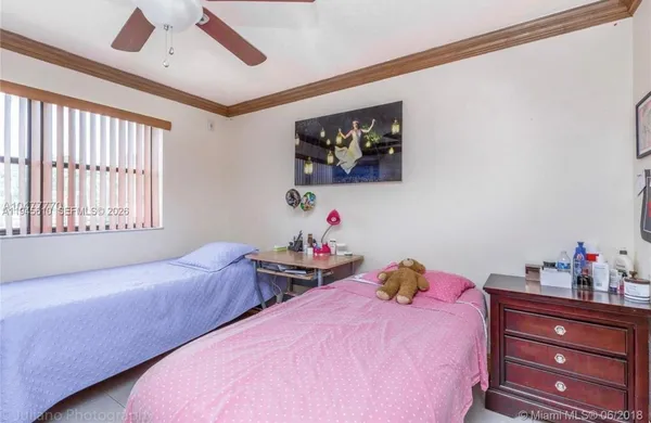 a bedroom with two beds and a window