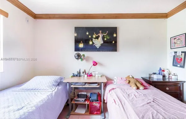 a bedroom that has a bed and a table in it