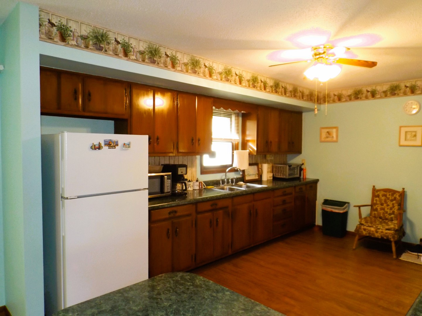 7573 Blue Goose Road Prophetstown, IL 61277 - Photo 9 of 24 a kitchen with cabinets a refrigerator and a sink