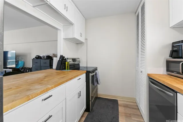 a kitchen that has a sink and a stove in it