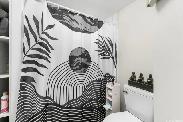 a view of a bedroom with a rug and wooden floor