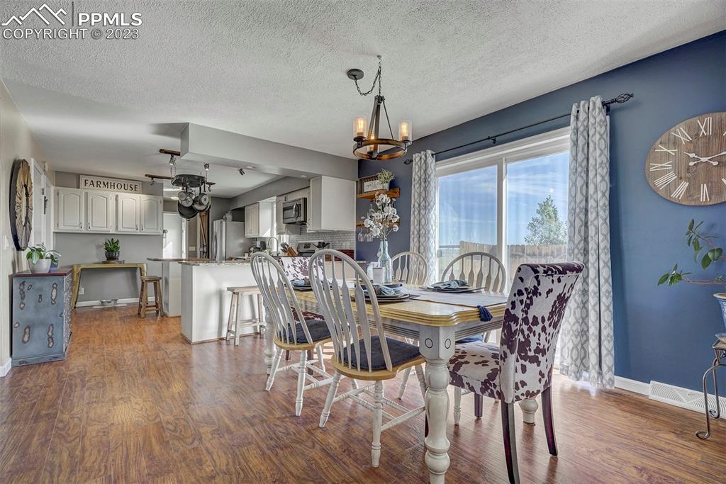 21750 Scott Road Calhan, CO 80808 - Photo 19 of 50 a view of a dining room with furniture window and wooden floor