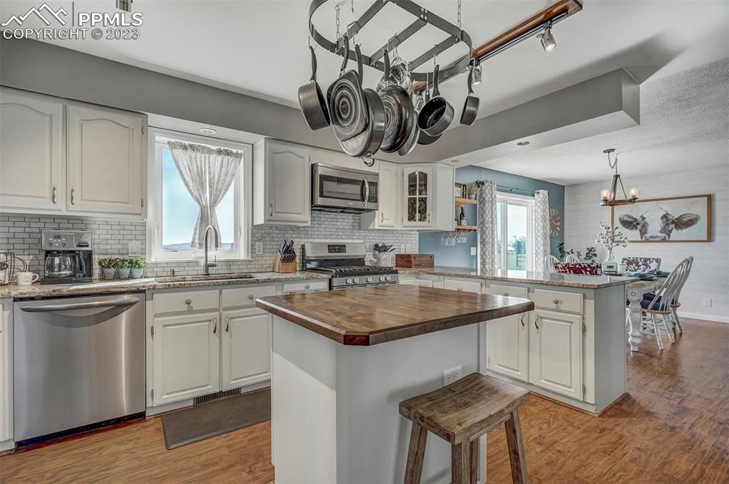 21750 Scott Road Calhan, CO 80808 - Photo 21 of 50 a kitchen with a sink a center island cabinets and a window