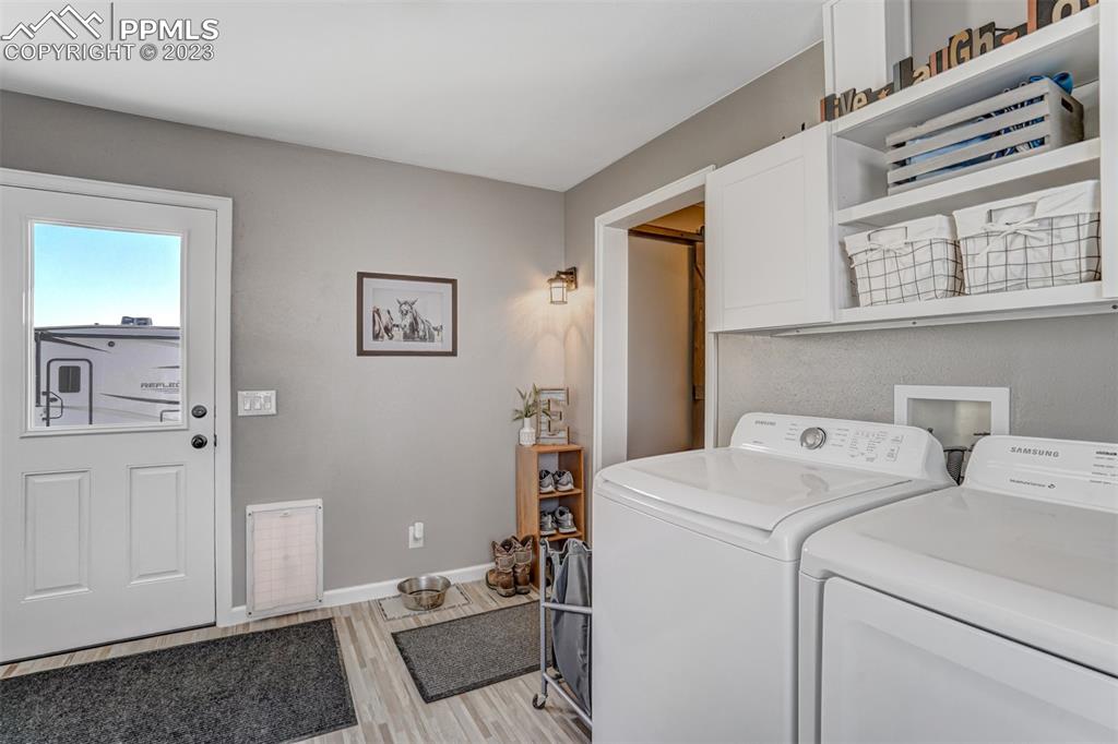 21750 Scott Road Calhan, CO 80808 - Photo 25 of 50 a view of washer and dryer with bathroom in the background