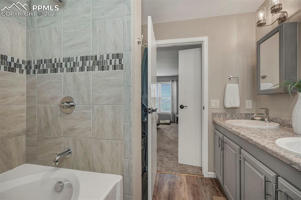 21750 Scott Road Calhan, CO 80808 - Photo 29 of 50 a bathroom with a granite countertop sink a mirror and shower
