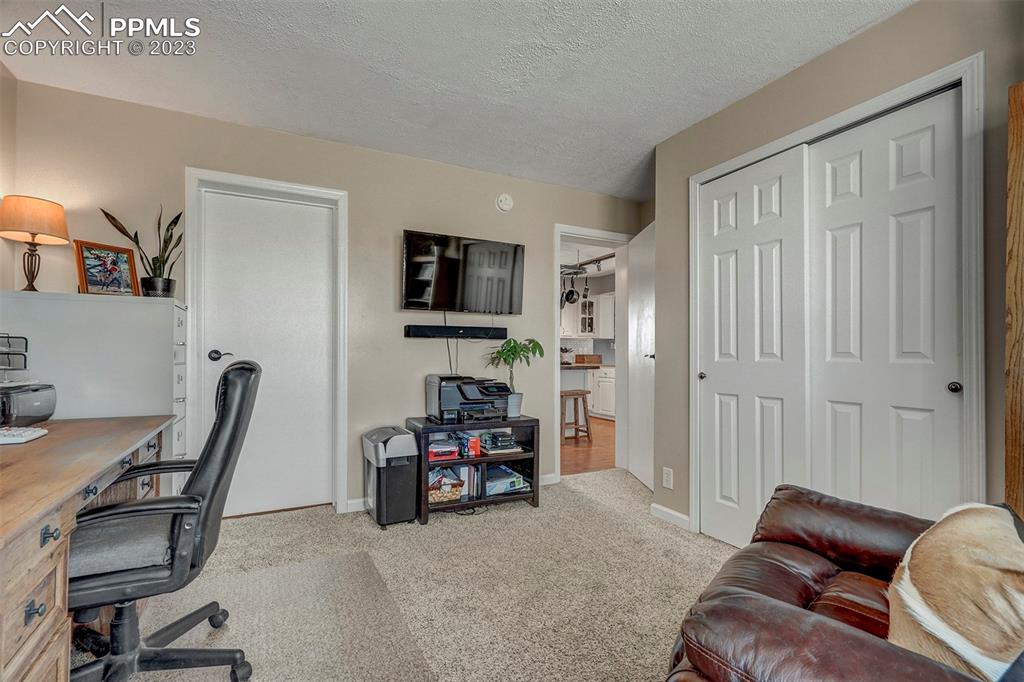 21750 Scott Road Calhan, CO 80808 - Photo 31 of 50 a view of a livingroom with workspace and a couch