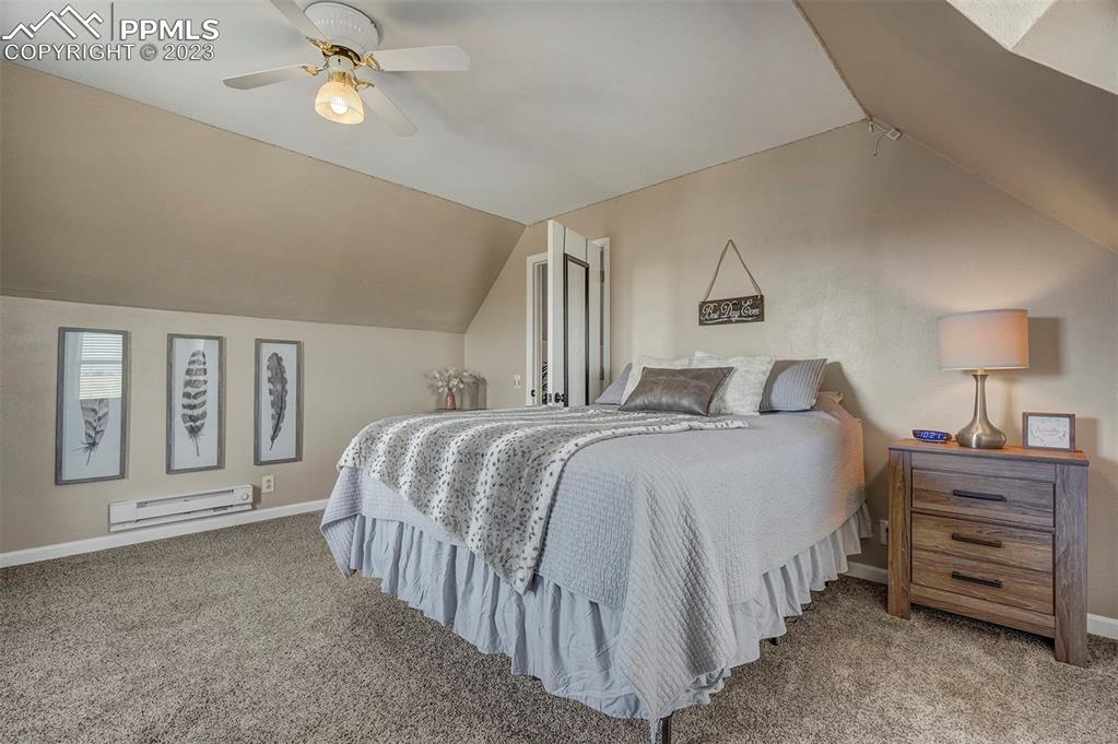 21750 Scott Road Calhan, CO 80808 - Photo 32 of 50 a bedroom with a bed and a lamp on dresser