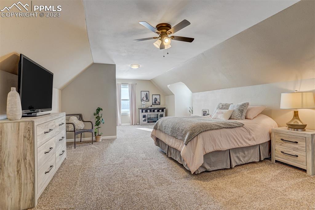 21750 Scott Road Calhan, CO 80808 - Photo 35 of 50 a spacious bedroom with a bed and a flat screen tv