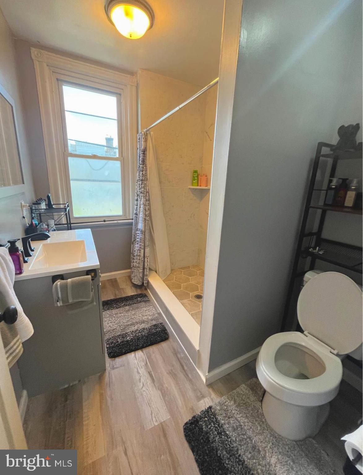4084 Higbee Street Philadelphia, PA 19135 - Photo 12 of 12 a bathroom with a toilet a sink and a mirror