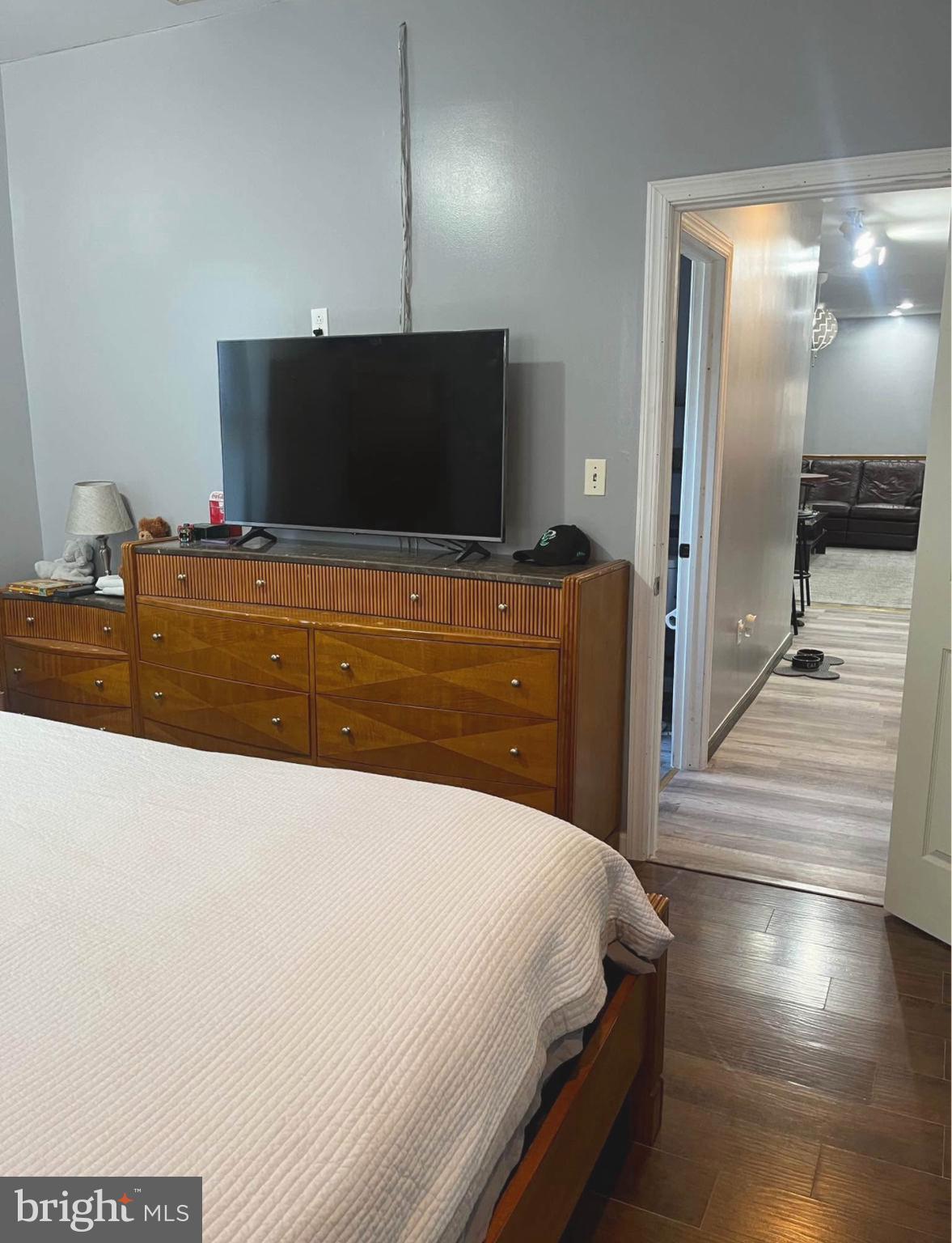 4084 Higbee Street Philadelphia, PA 19135 - Photo 6 of 12 a bedroom with a bed and a flat screen tv