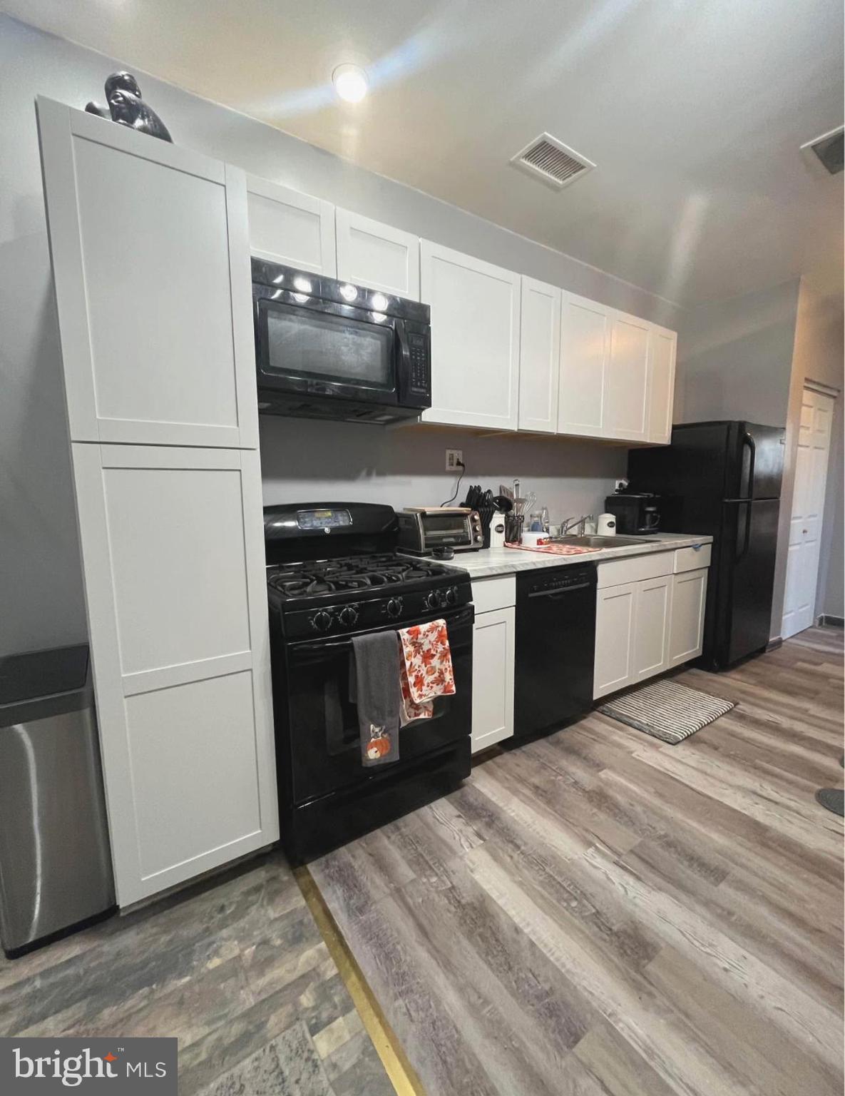 4084 Higbee Street Philadelphia, PA 19135 - Photo 7 of 12 a kitchen with a stove top oven and refrigerator