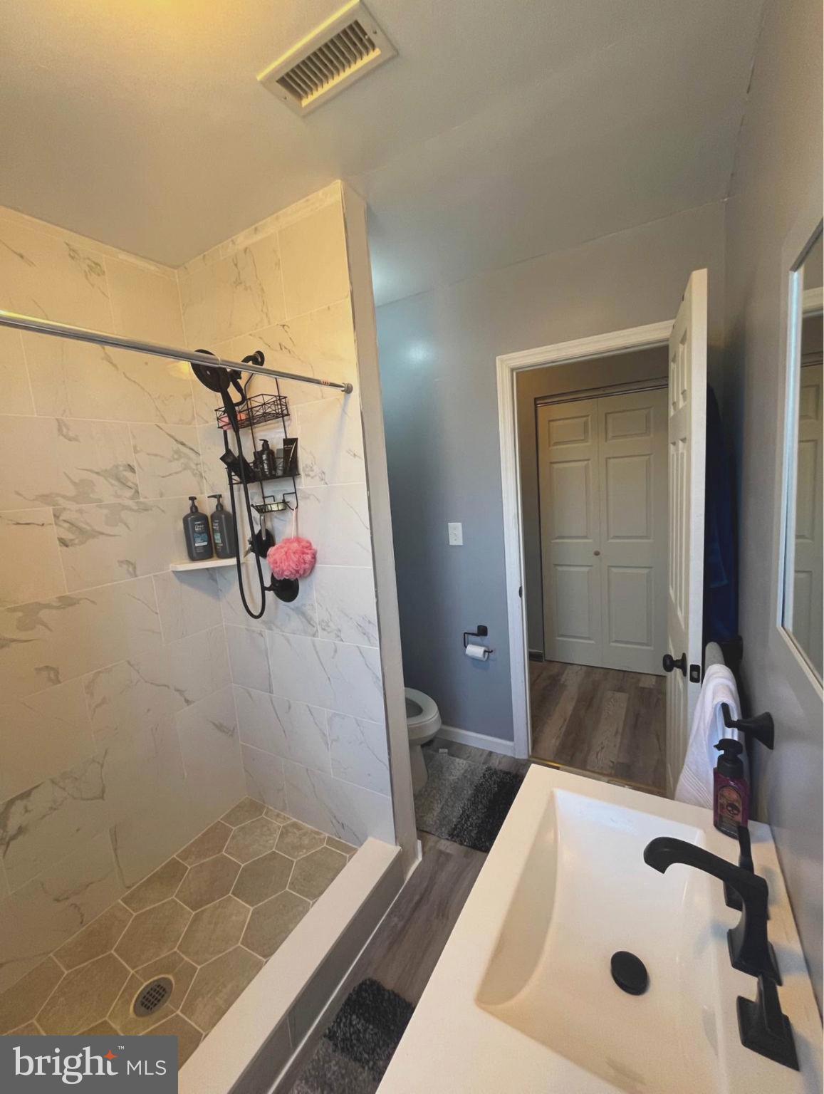 4084 Higbee Street Philadelphia, PA 19135 - Photo 10 of 12 a bathroom with a sink and a mirror