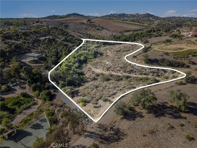 a view of a backyard with wooden fence