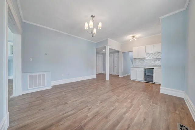 a kitchen with stainless steel appliances granite countertop a refrigerator a sink a stove and a cabinets