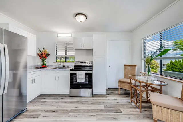 a kitchen with a refrigerator and windows