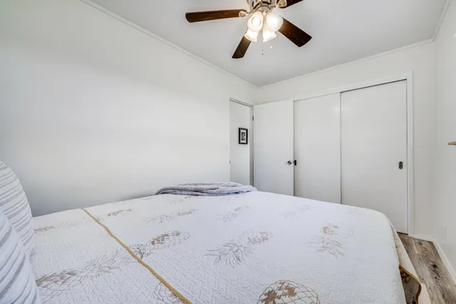 a bedroom with a large bed and a chandelier