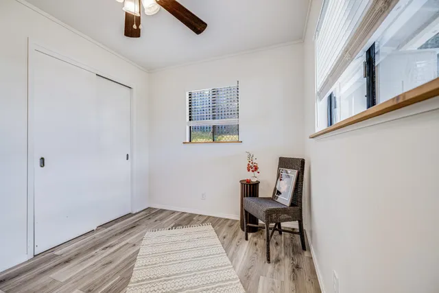 a view of a room with furniture and wooden floor