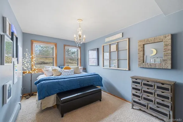 a bedroom with a bed a mirror and a window