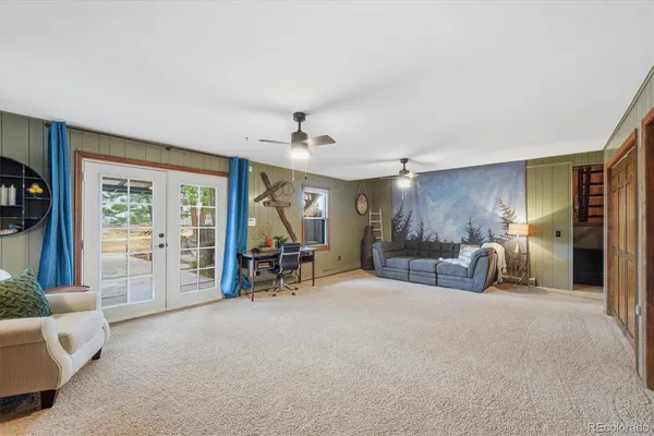 a living room with furniture and a clock