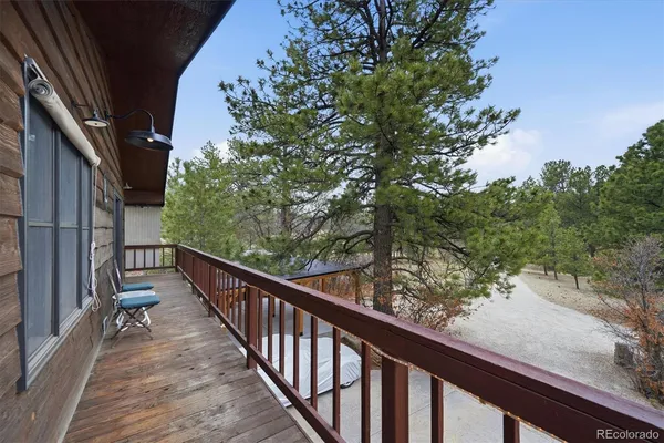 a view of balcony with wooden floor and fence