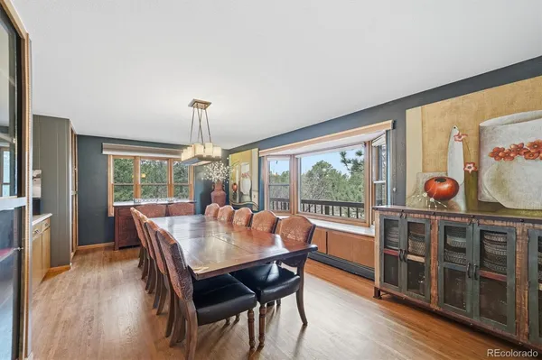 a view of a dining room with furniture window and wooden floor