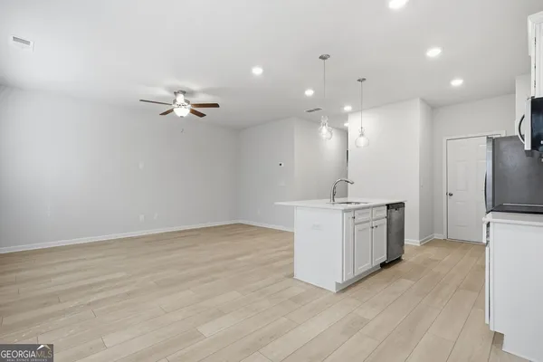 a view of kitchen with sink microwave and refrigerator