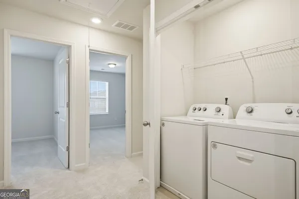 a view of a bathroom with sink mirror and window