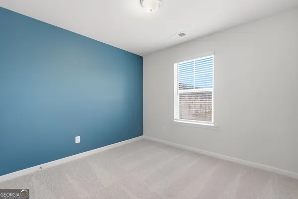an empty room with closet area