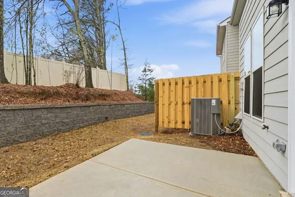 a view of a house with wooden fence