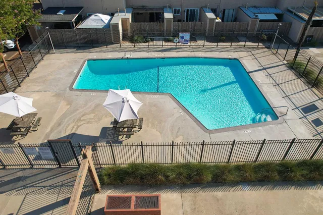 a view of swimming pool with outdoor seating and yard
