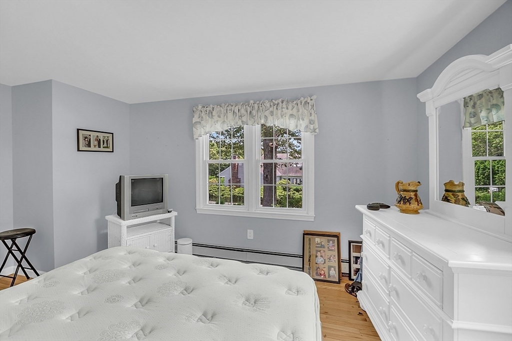 89 Kingswear Circle Dennis, MA 02660 - Photo 23 of 40 a bedroom with a bed a large window and flat screen tv