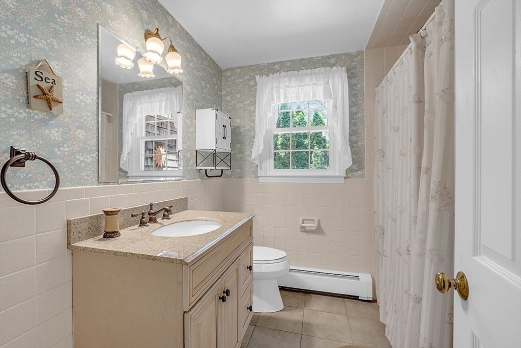 89 Kingswear Circle Dennis, MA 02660 - Photo 25 of 40 a bathroom with a sink a toilet and a mirror