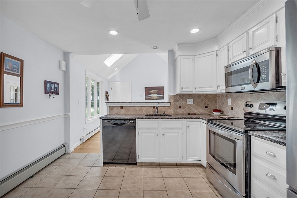 89 Kingswear Circle Dennis, MA 02660 - Photo 30 of 40 a kitchen with stainless steel appliances granite countertop a stove top oven a sink dishwasher and a refrigerator