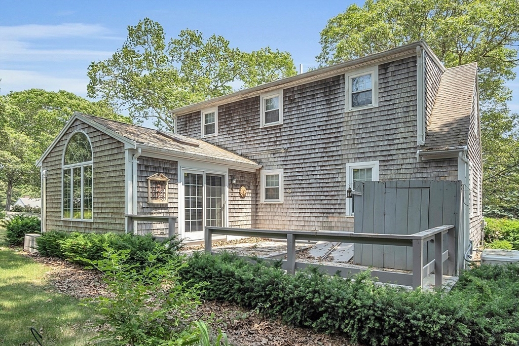 89 Kingswear Circle Dennis, MA 02660 - Photo 4 of 40 a view of a house with a yard and plants