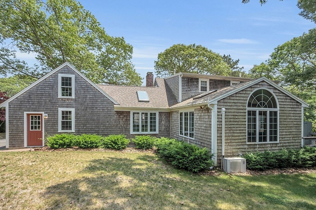 89 Kingswear Circle Dennis, MA 02660 - Photo 6 of 40 a front view of a house with a yard and trees