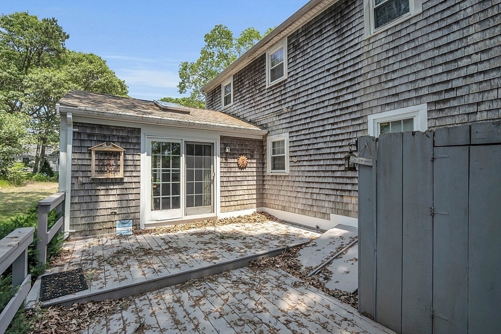 89 Kingswear Circle Dennis, MA 02660 - Photo 8 of 40 a front view of a house with a yard