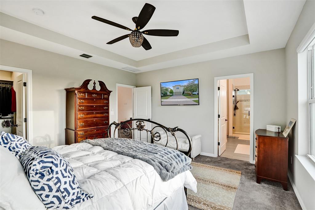 1612 Trailhead Terrace Hollywood, FL 33021 - Photo 26 of 71 a bedroom with a large bed and a chandelier