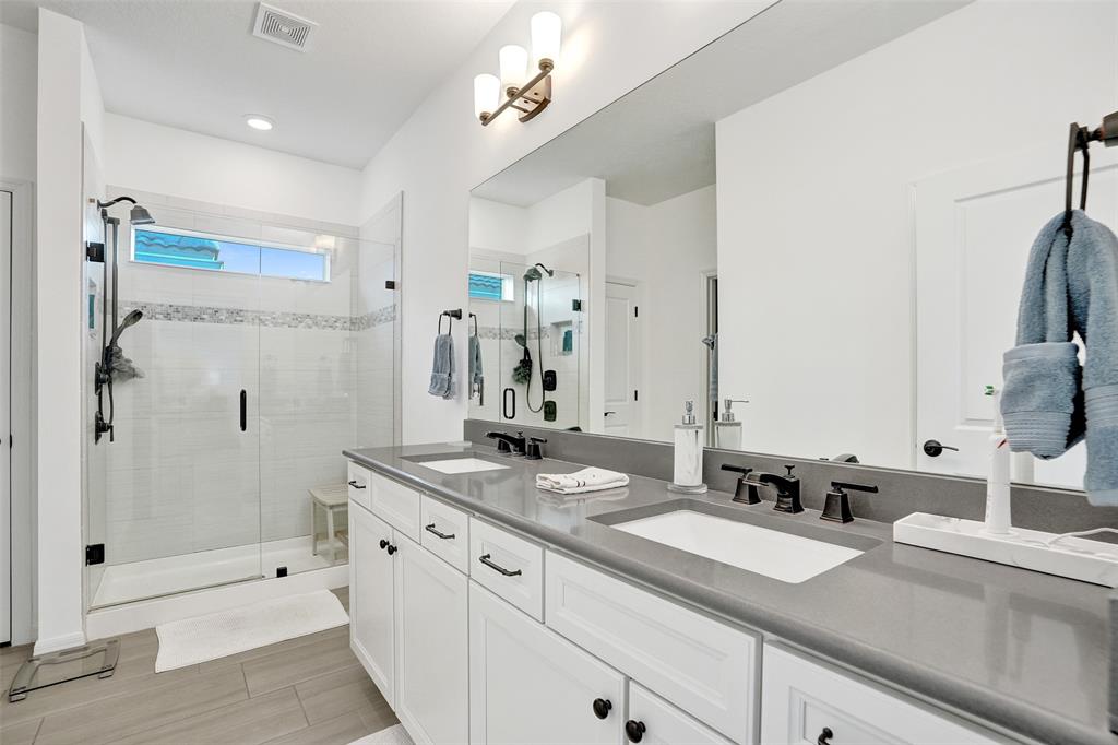 1612 Trailhead Terrace Hollywood, FL 33021 - Photo 29 of 71 a spacious bathroom with double sink a a mirror a shower and a bathtub