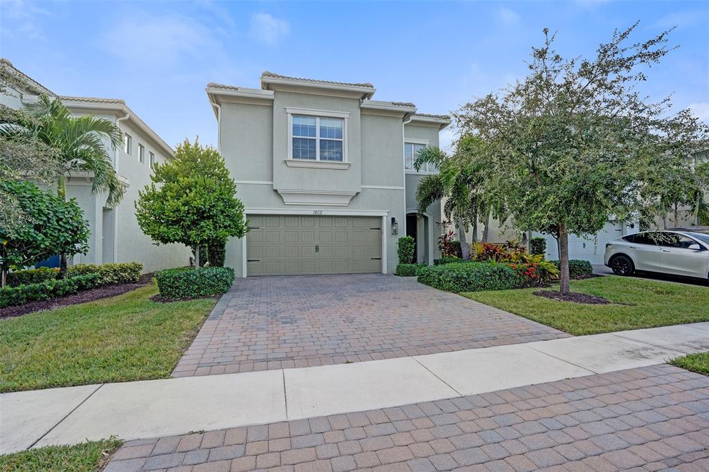 1612 Trailhead Terrace Hollywood, FL 33021 - Photo 70 of 71 a front view of a house with a yard and a garage
